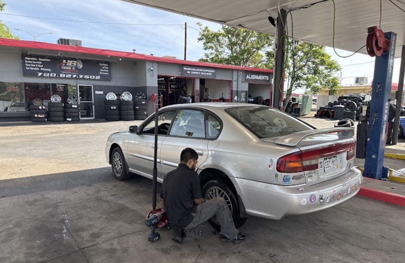 HB Tires & Wheels technician servicing a customer's vehicle